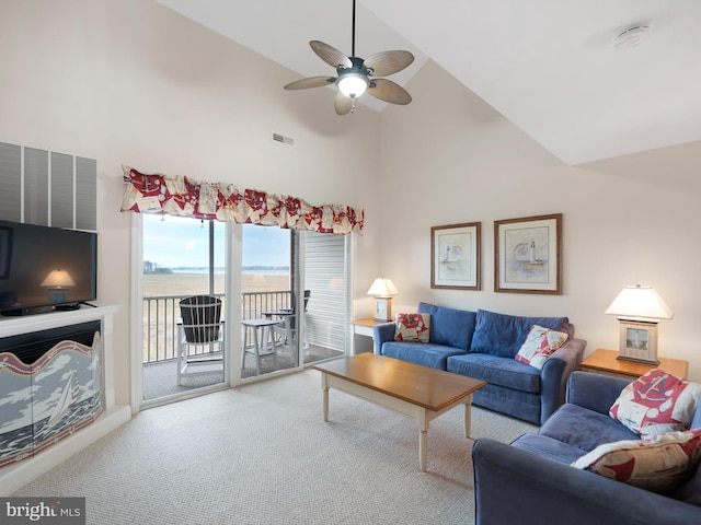 carpeted living room featuring ceiling fan, a water view, and high vaulted ceiling