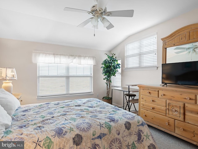 carpeted bedroom with ceiling fan, vaulted ceiling, and multiple windows