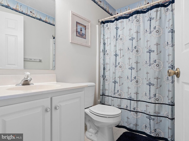 bathroom featuring vanity, toilet, and curtained shower