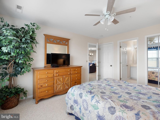 bedroom with ensuite bath, ceiling fan, and light colored carpet