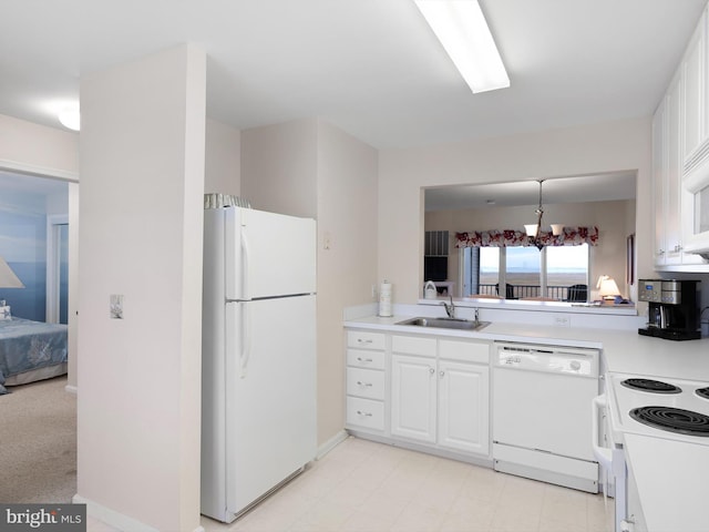 kitchen featuring pendant lighting, white cabinetry, white appliances, and sink