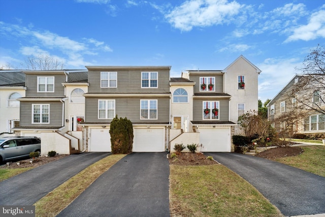 multi unit property featuring a garage