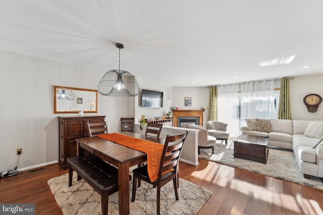 dining space with hardwood / wood-style flooring