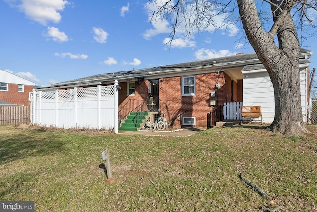 rear view of property with a yard