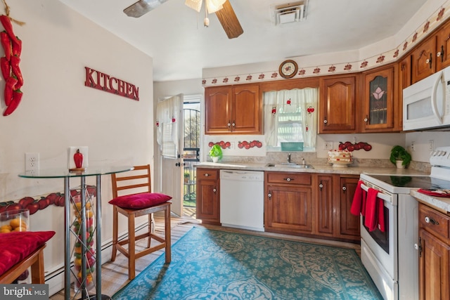 kitchen with plenty of natural light, ceiling fan, white appliances, and sink