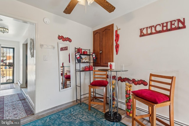 dining space with hardwood / wood-style flooring and ceiling fan