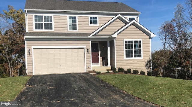 view of front of property featuring a garage and a front lawn