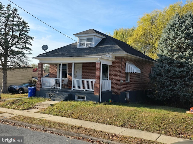 bungalow-style house with a front lawn and a porch