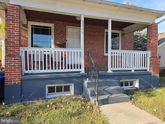 doorway to property featuring covered porch