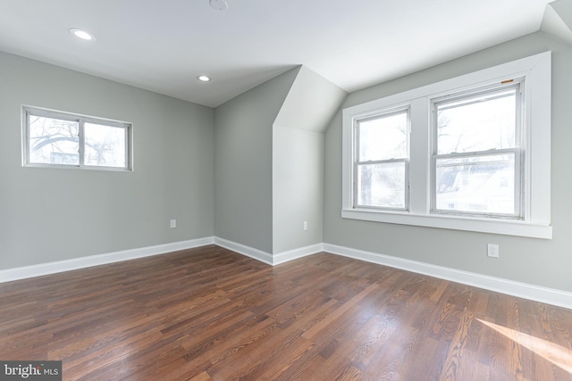 additional living space with dark hardwood / wood-style floors