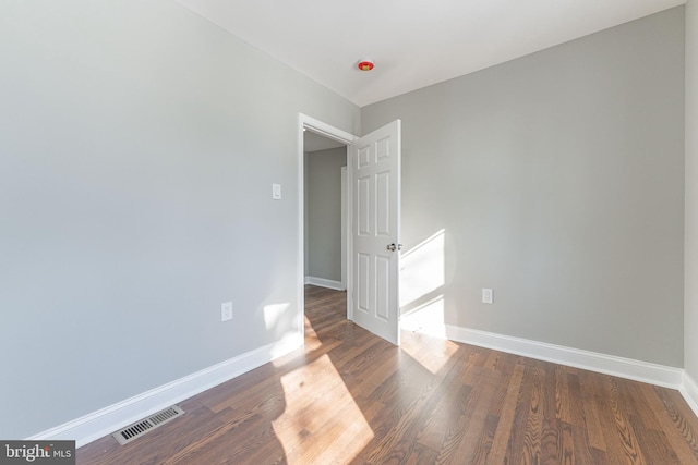 spare room with dark hardwood / wood-style floors