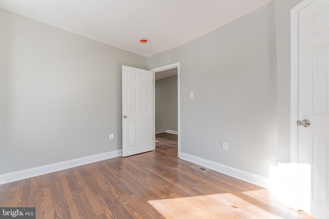 spare room with hardwood / wood-style floors