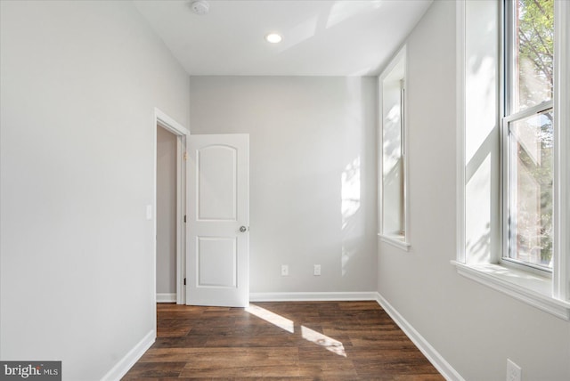 spare room with dark wood-type flooring