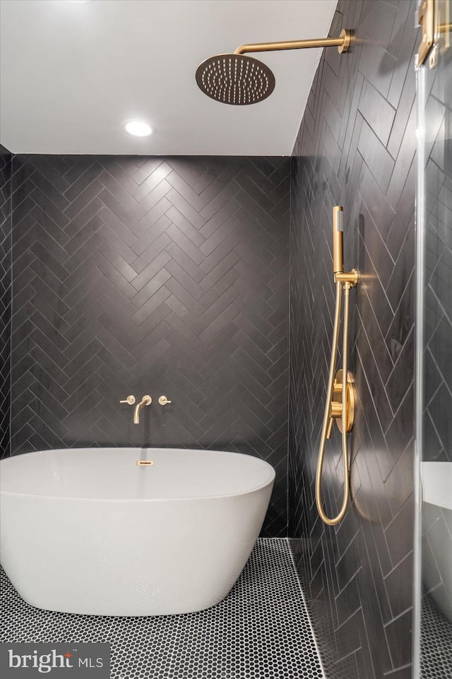 bathroom with tile patterned flooring, tile walls, and independent shower and bath