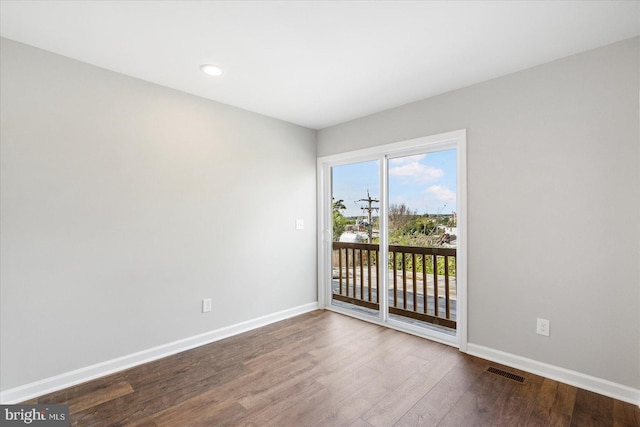 unfurnished room featuring hardwood / wood-style flooring