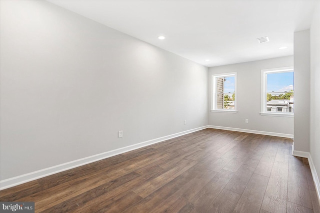 spare room featuring dark wood-type flooring