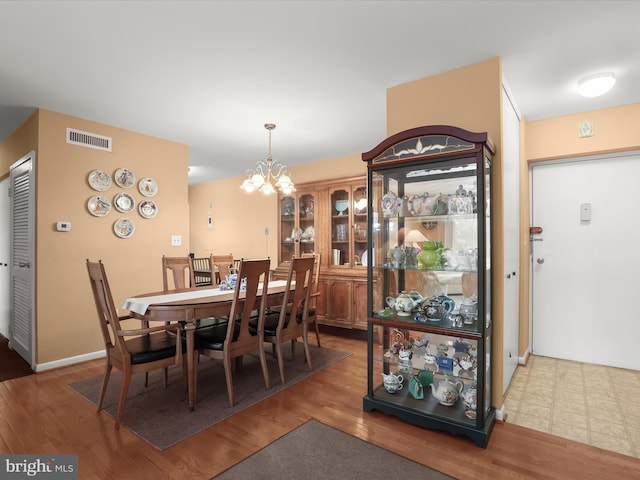 dining room featuring hardwood / wood-style flooring and a notable chandelier