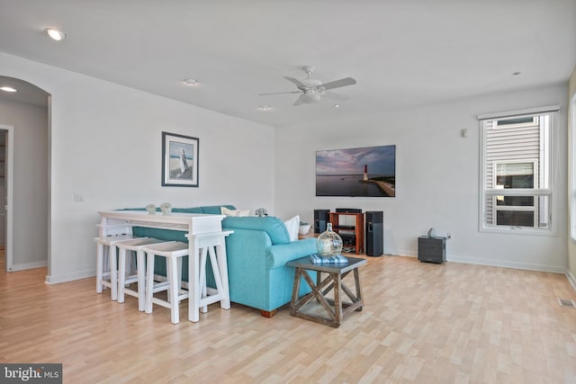 living room with ceiling fan and light wood-type flooring