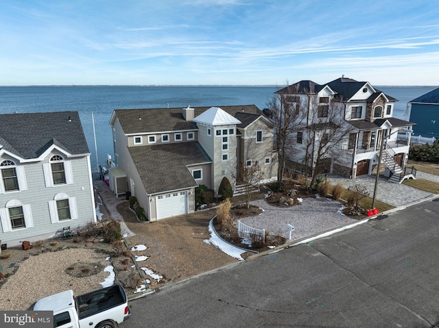 view of front of home with a water view and a garage