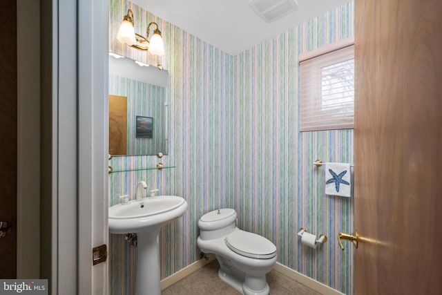 bathroom featuring sink, tile patterned floors, and toilet