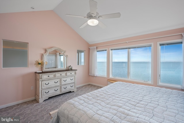 bedroom featuring ceiling fan, light colored carpet, lofted ceiling, and a water view