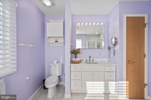 bathroom with toilet, tile patterned flooring, an enclosed shower, and vanity