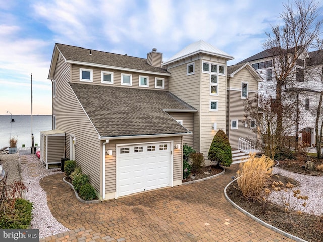 view of front of house featuring a garage and central AC