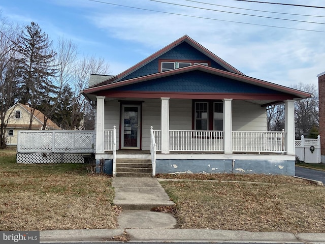 bungalow-style home with a front yard and a porch