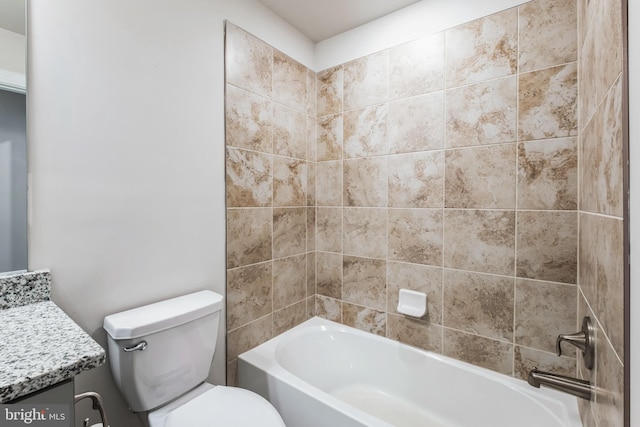 full bathroom featuring toilet, vanity, and tiled shower / bath