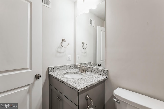 bathroom featuring toilet and vanity