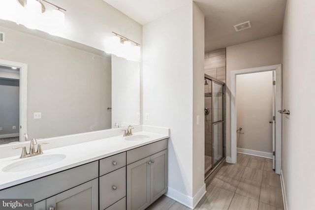 bathroom featuring walk in shower and vanity