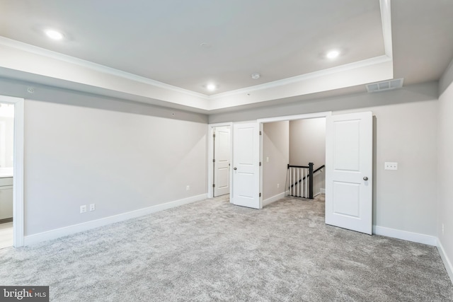 basement with light colored carpet and ornamental molding