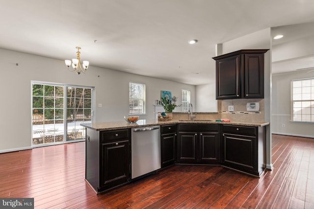 kitchen with dark hardwood / wood-style floors, dishwasher, sink, and light stone countertops