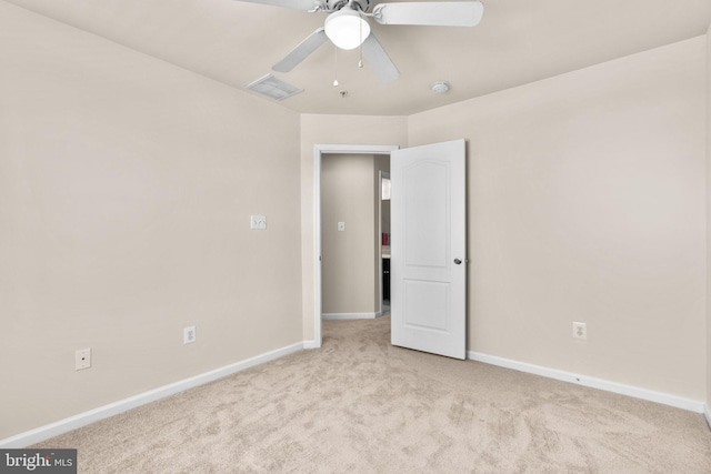 unfurnished room featuring light colored carpet and ceiling fan