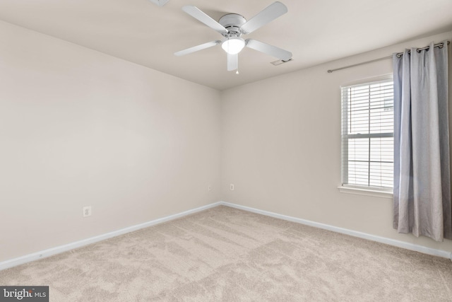 carpeted empty room featuring ceiling fan