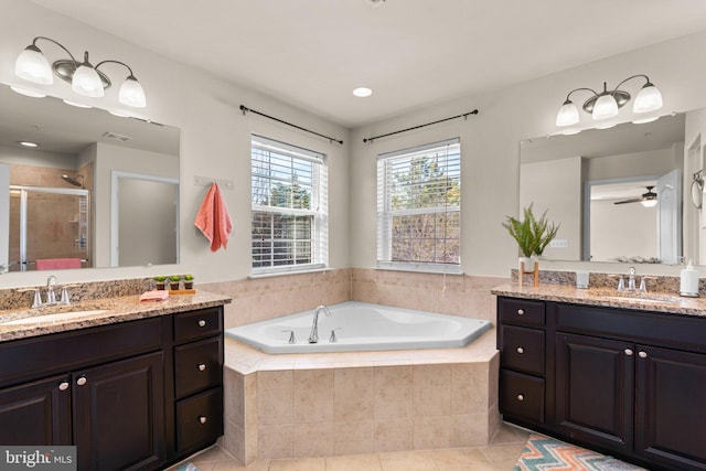 bathroom with plus walk in shower, vanity, and tile patterned floors