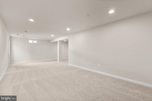 basement featuring light colored carpet