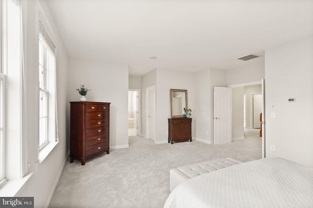 carpeted bedroom with multiple windows