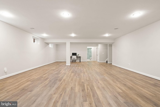 basement with light hardwood / wood-style flooring