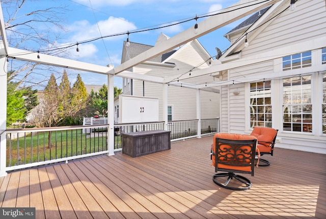 wooden terrace featuring a lawn