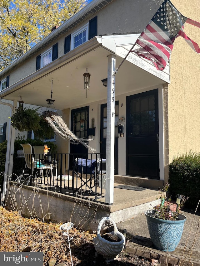 view of exterior entry with covered porch