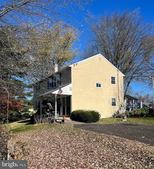 rear view of property with covered porch