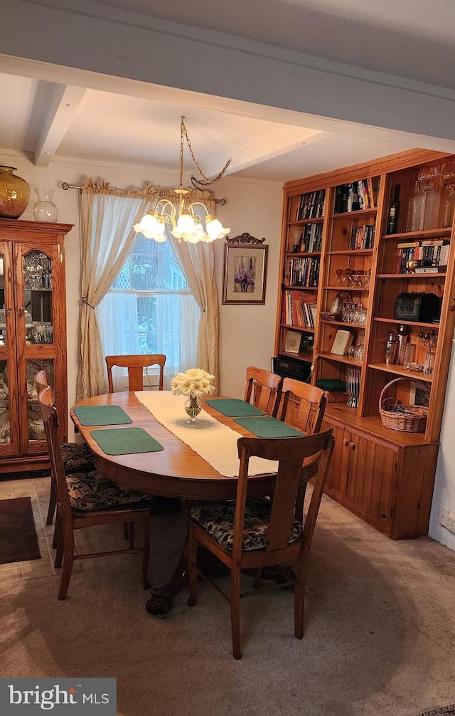 carpeted dining room with beam ceiling and an inviting chandelier