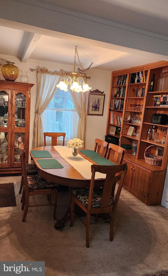 carpeted dining room with beamed ceiling and a chandelier