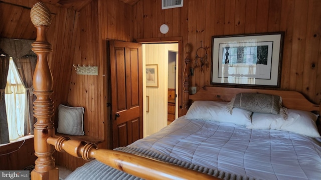 bedroom featuring wood walls