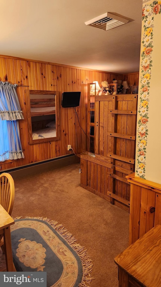 carpeted living room with wooden walls