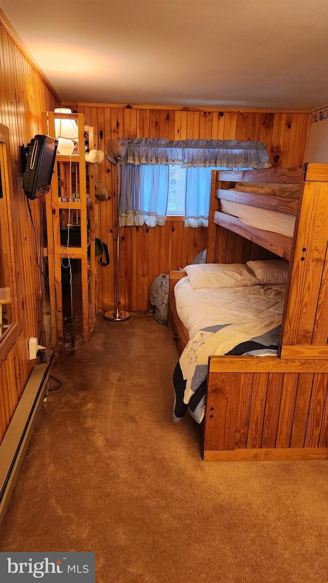 carpeted bedroom featuring wood walls