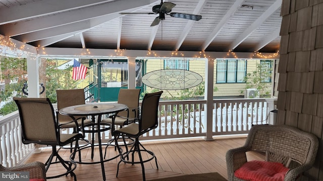 sunroom with beam ceiling and ceiling fan