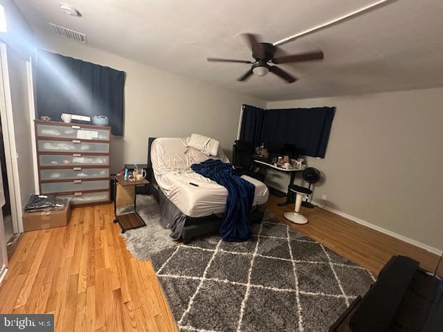 bedroom with ceiling fan and hardwood / wood-style flooring