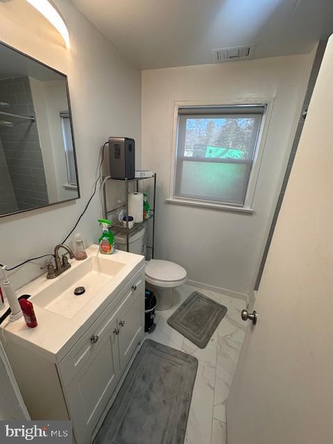 bathroom with vanity and toilet